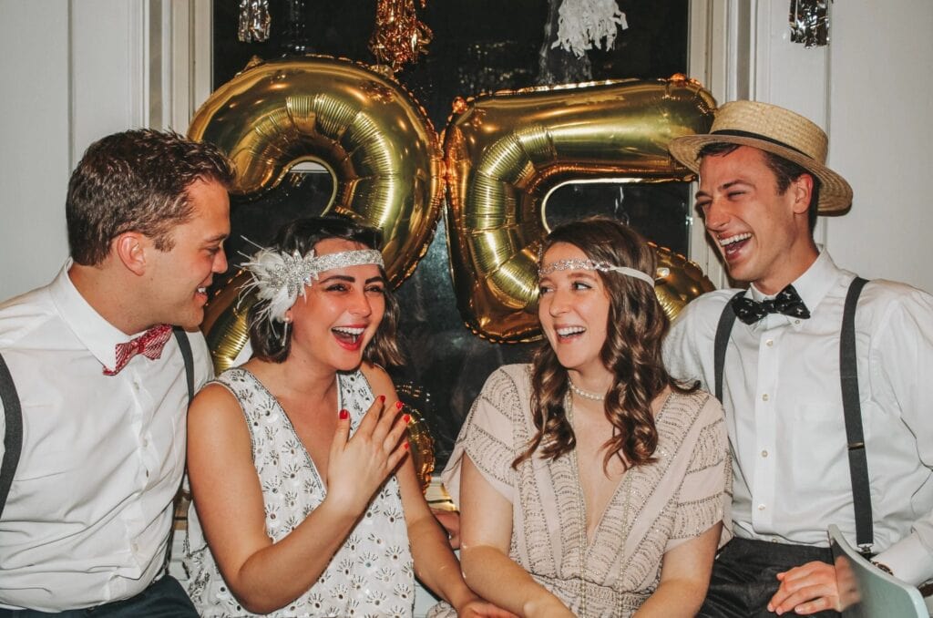 friends in vintage clothes laughing at a party