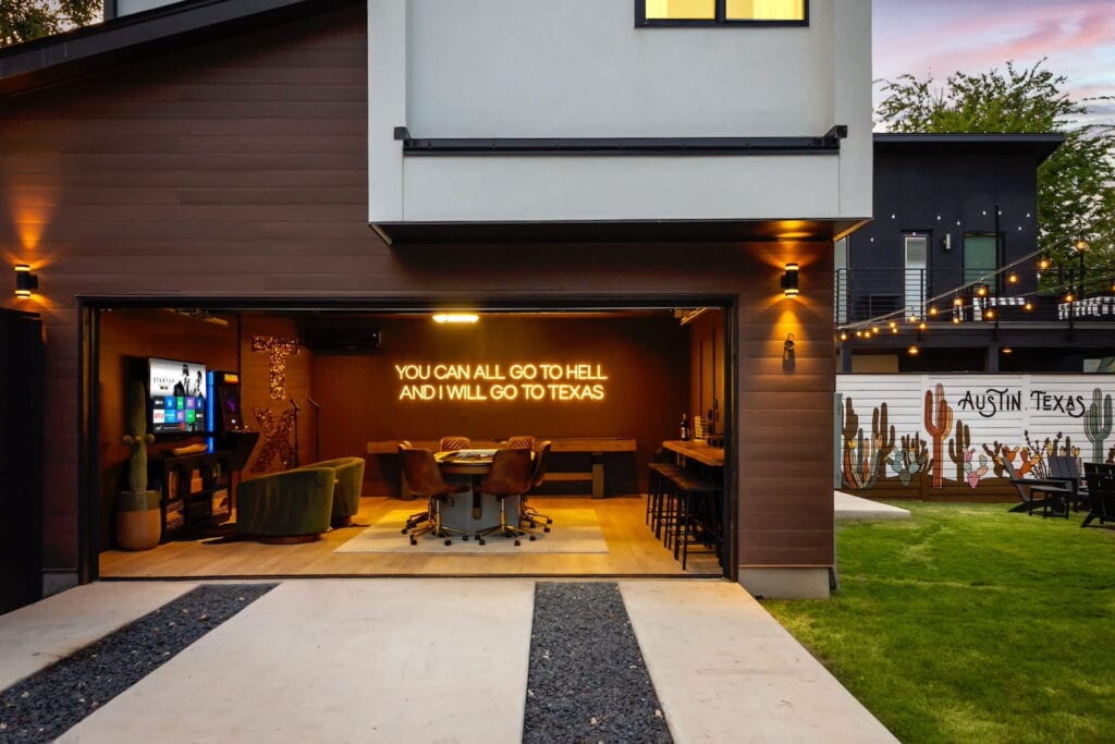 Exterior shot of a garage in Austin with a bar, big screen TV, and game table