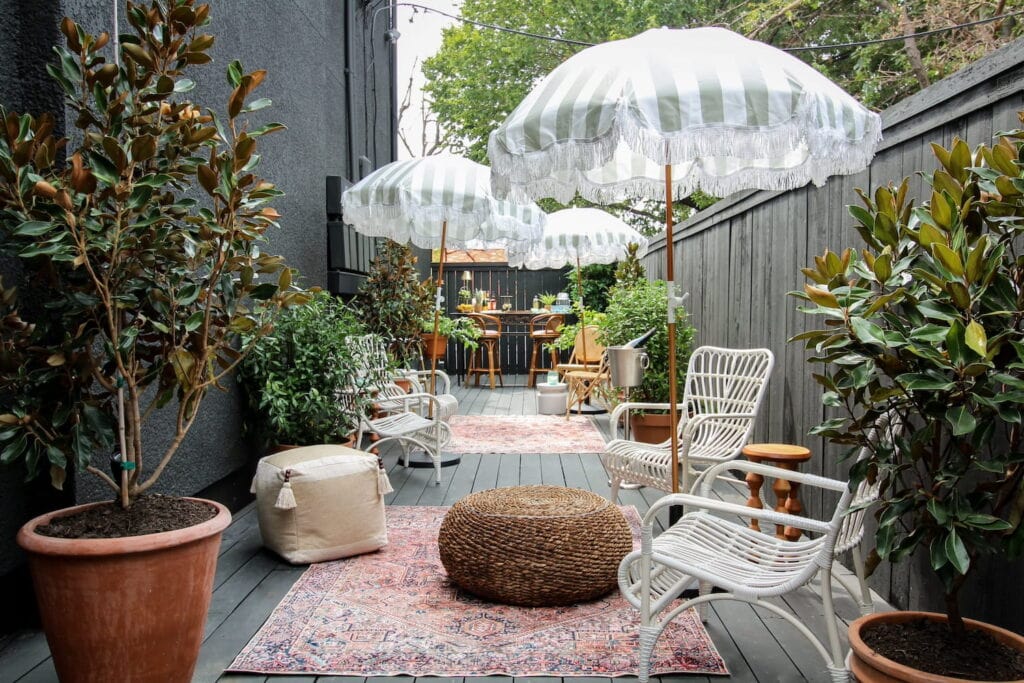 Romantic garden space in Dallas with multiple seating areas, striped umbrellas, and greenery