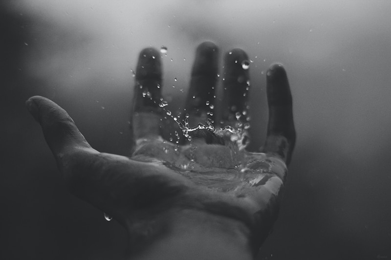 Photo of hand catching a raindrop