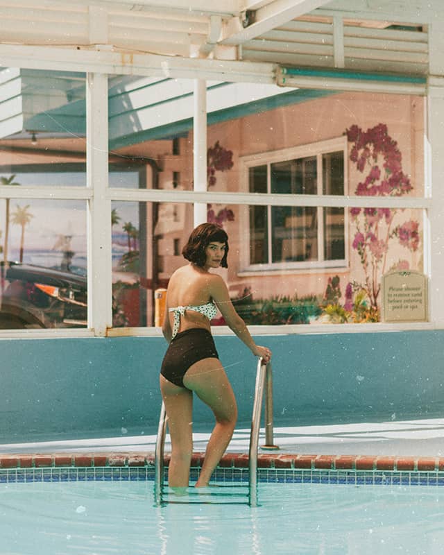 woman emerging from swimming pool