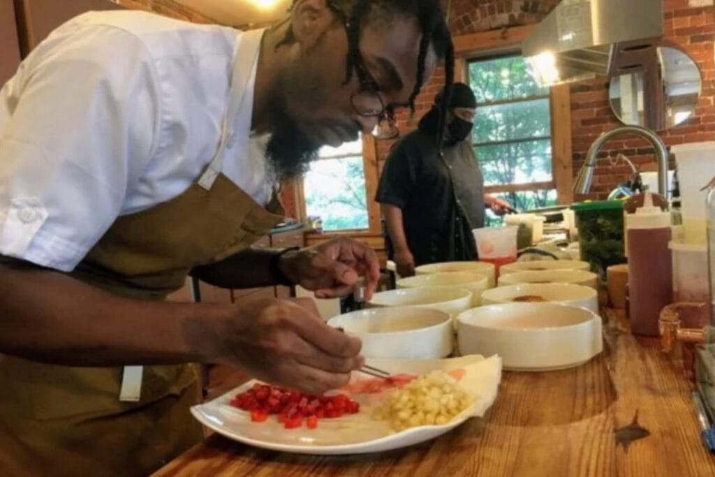 Chef Demetrius Brown puts the finishing touches on a signature dish