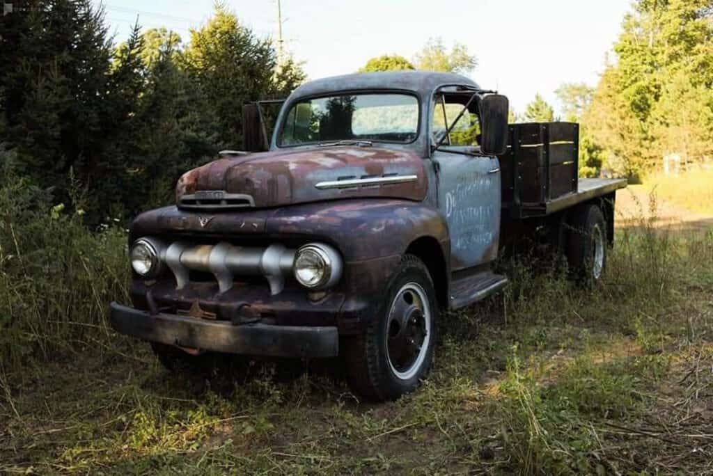 a vintage truck in a field