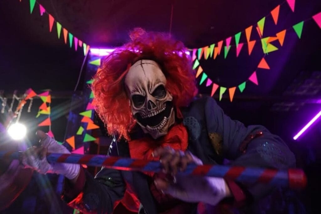 Creepy clown with skull face in attack mode