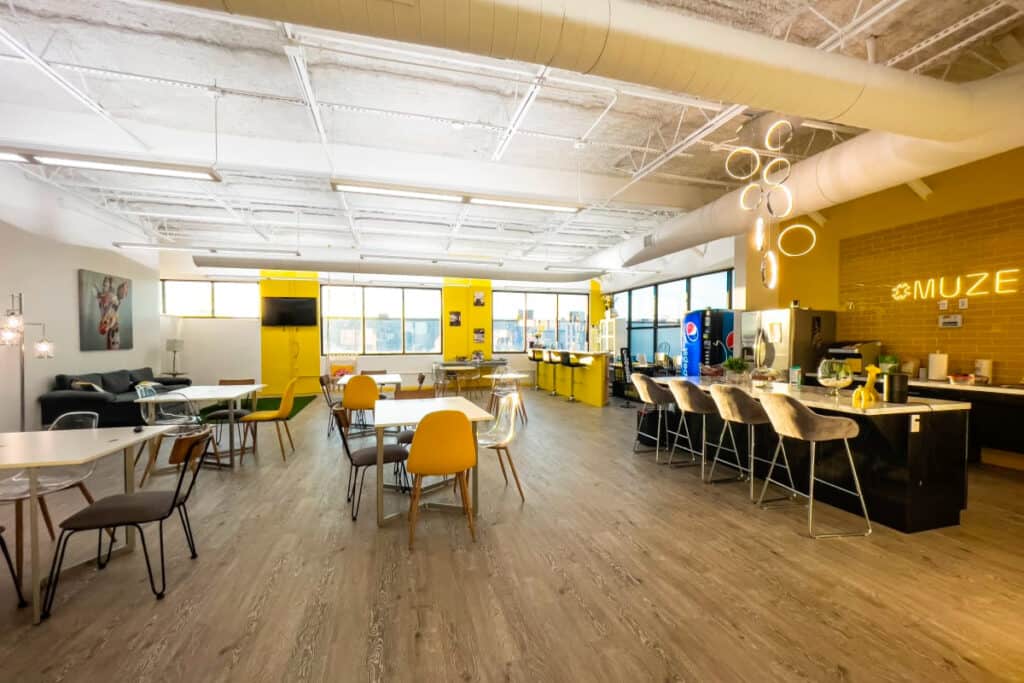 An industrial meeting space with plenty of chairs and tables