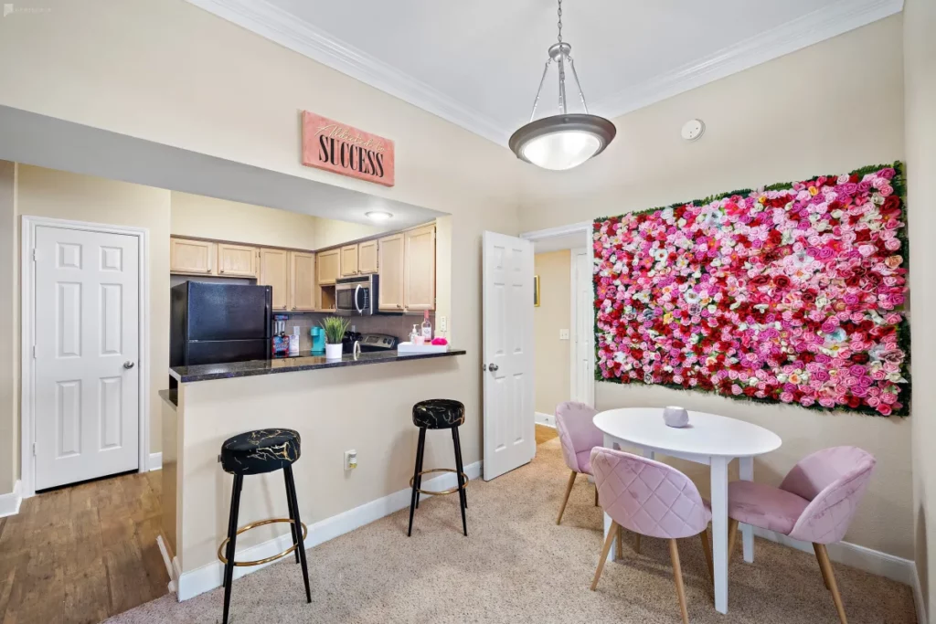 an apartment kitchen with a flower wall