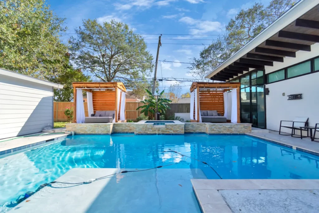 a pool and hot tub in a houston backyard