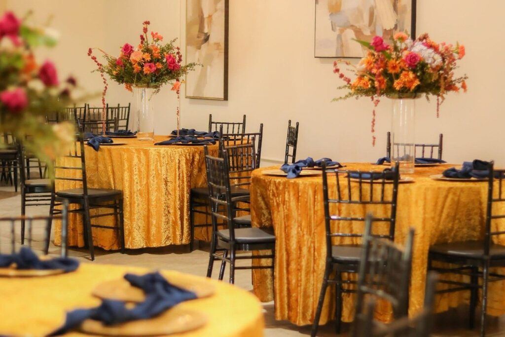 Gold sequined tablecloths and vibrant floral centerpieces for Chicago Indian wedding reception