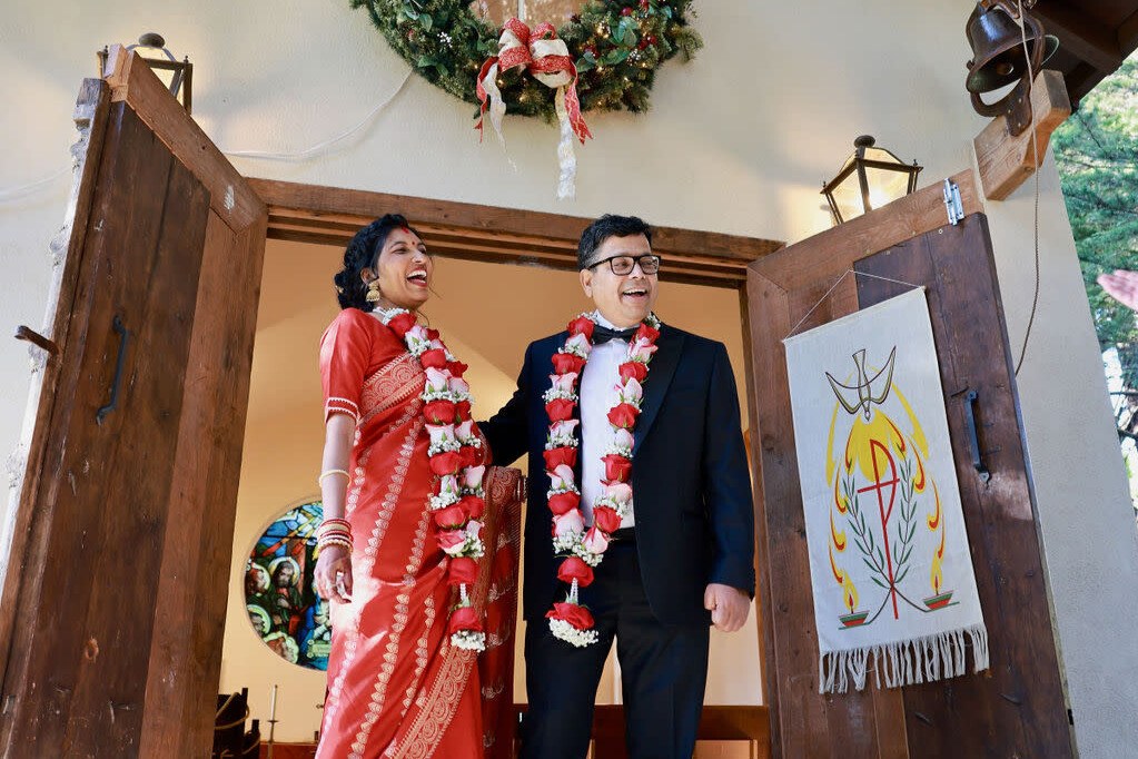 Couple in traditional Indian wedding attire with floral garlands in Chicago