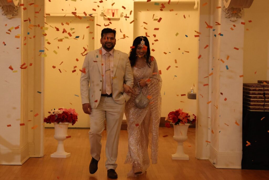 South Asian couple celebrating amid confetti at Chicago Indian wedding reception
