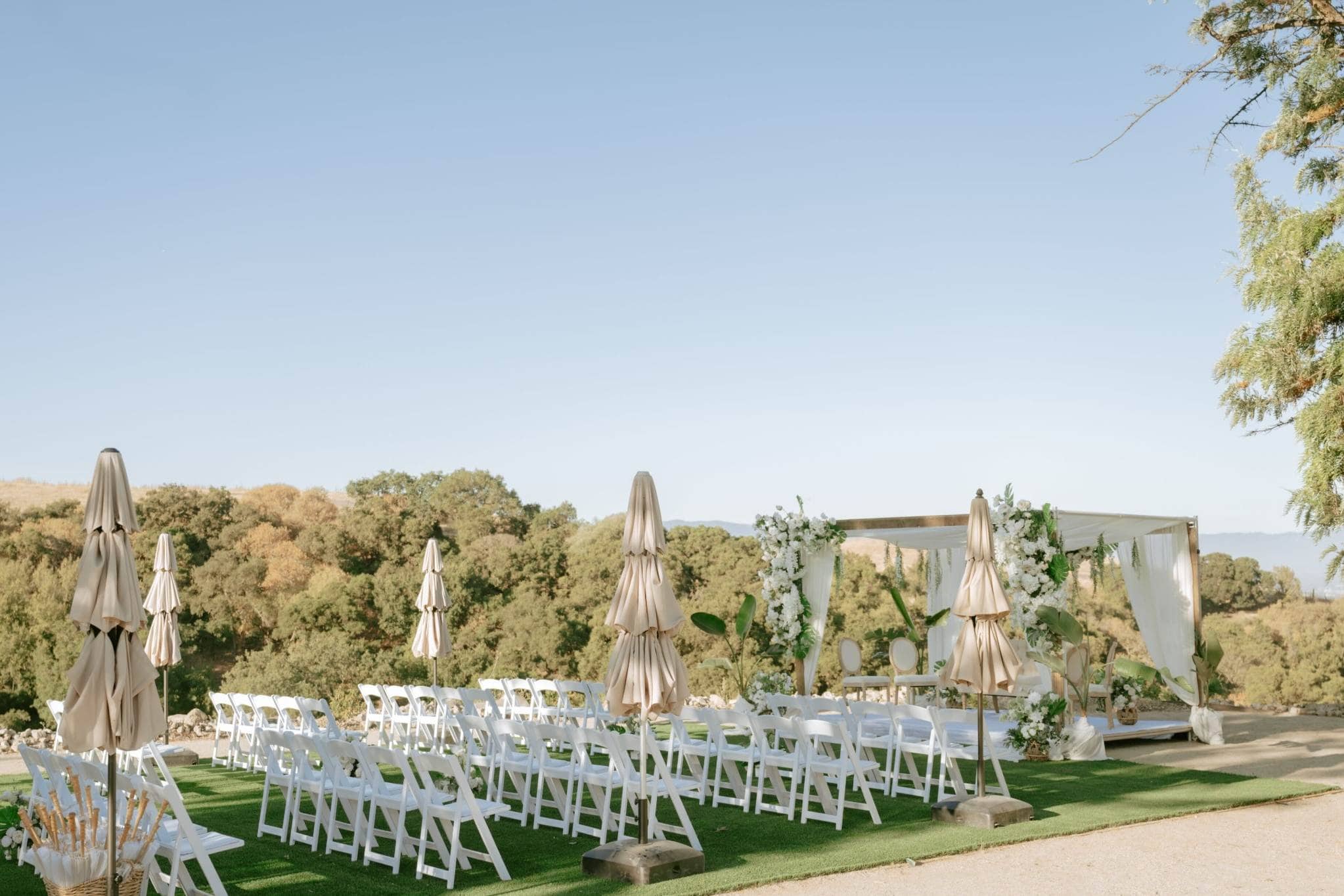 Indian wedding planners in Hawaii styling a colorful mandap and floral decor