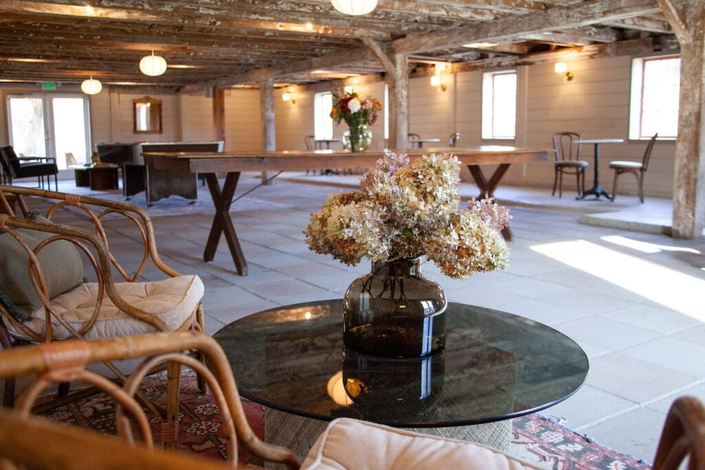 Interior of a modernized barn space with tile flooring and shiplap walls