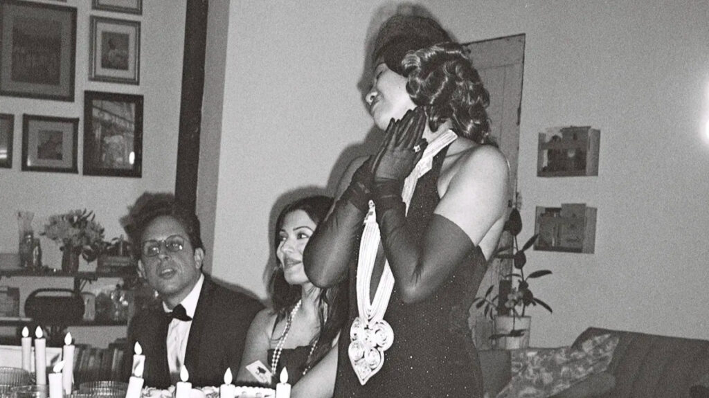 birthday party host at murder mystery party beams amongst friends