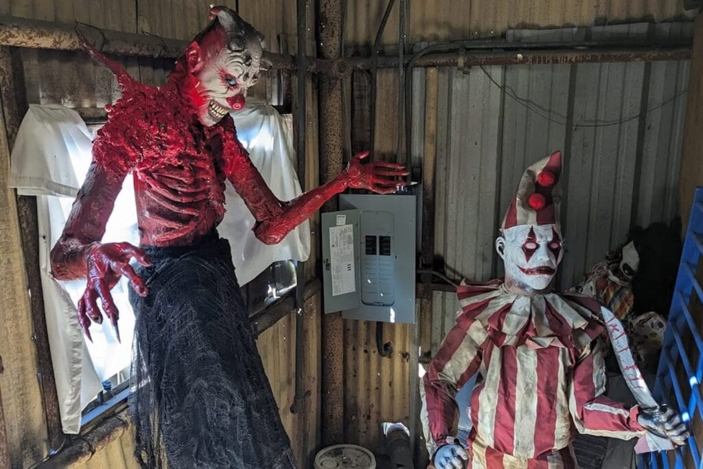 Creepy clown decorations in a junkyard warehouse