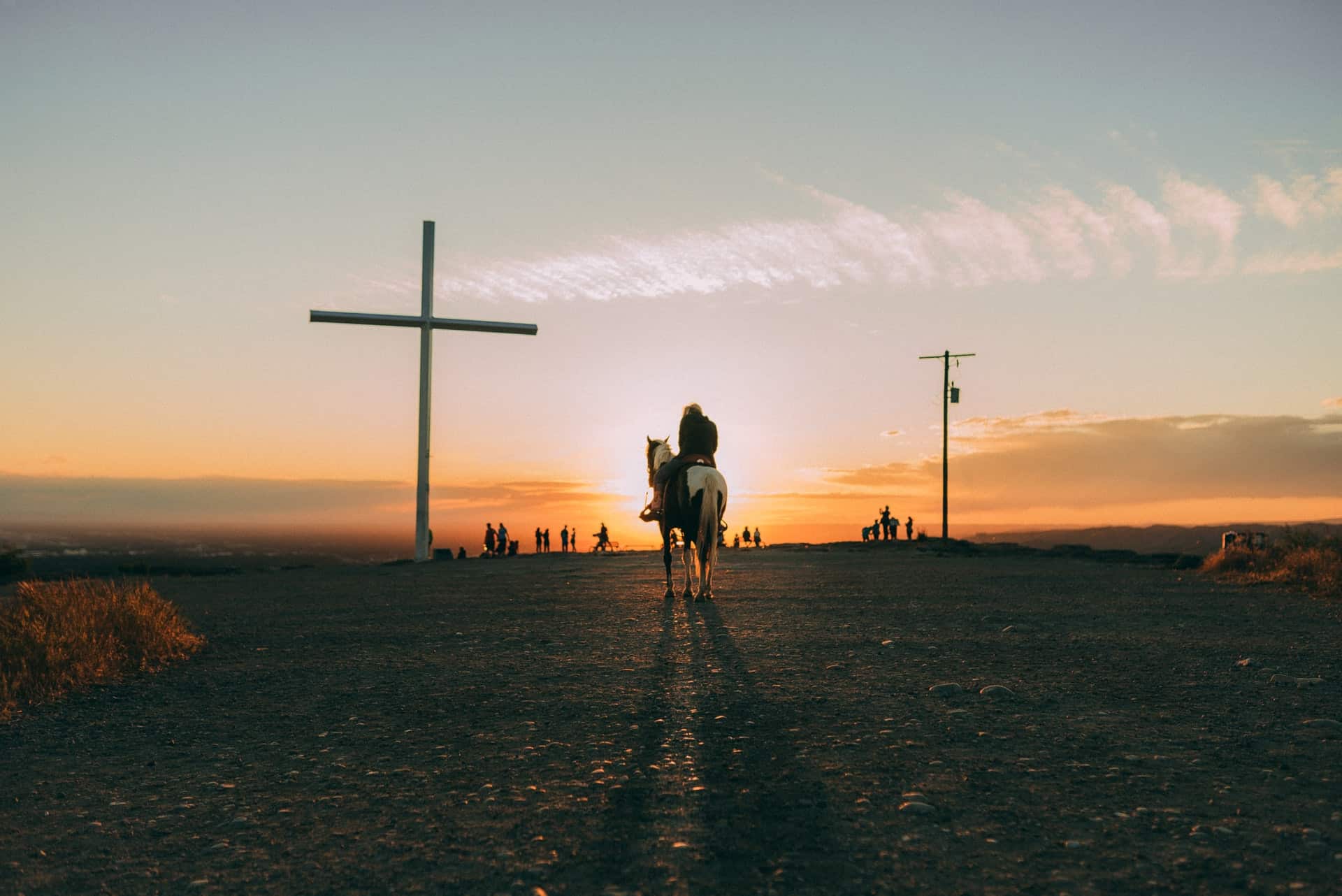 person on horse riding into the sunset