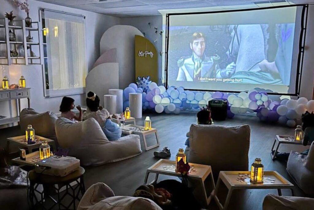 kids watching a movie at an event venue