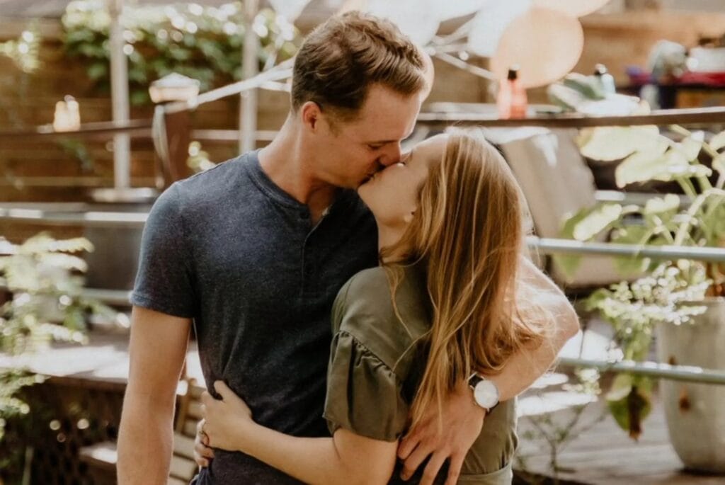a couple kissing at their engagement party