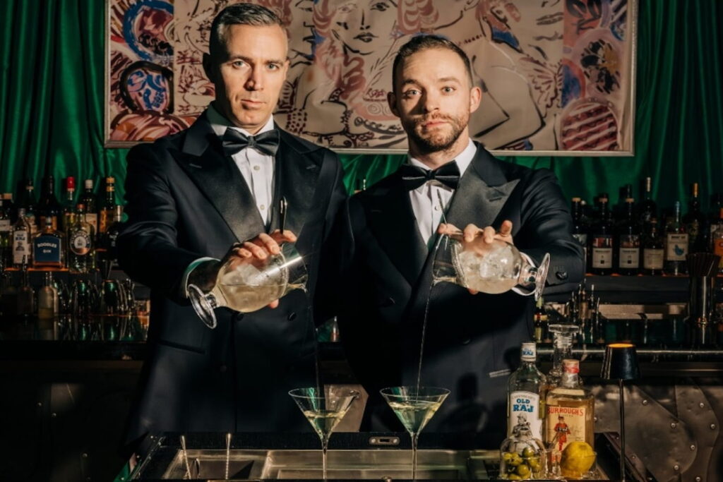 Bartenders pour cocktails at Kitty's Cosmopolitan Club in Chicago
