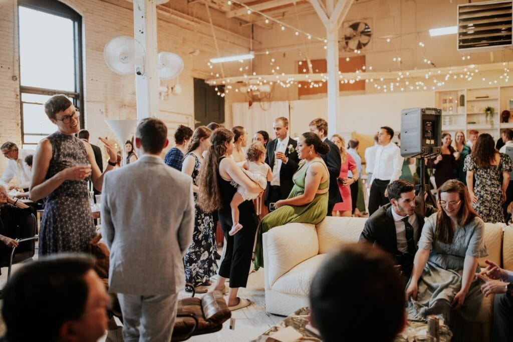 A loft-style party space filled with party goers