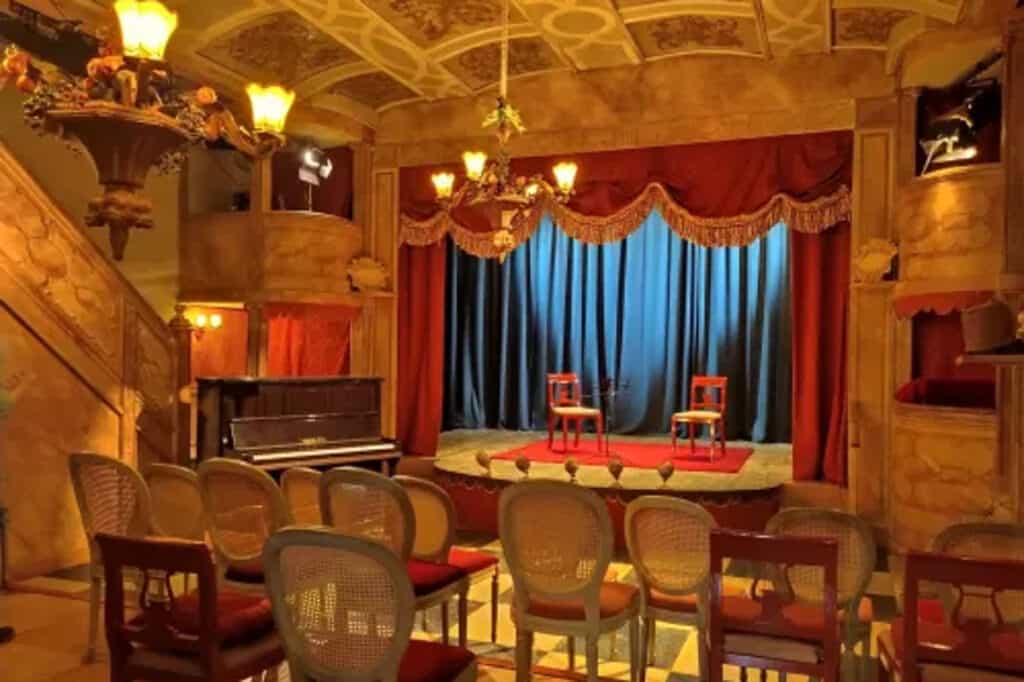 london independent studio with a stage and velvet curtains