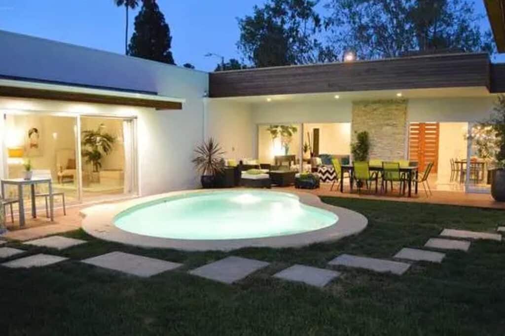 a pool outside a mid-century modern home