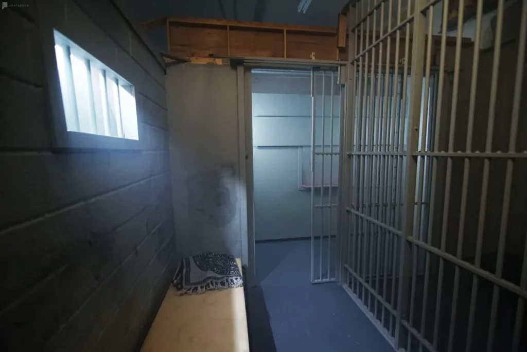 jail set with rolling bars and cots