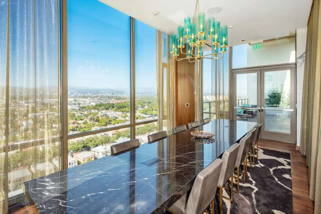 Swanky boardroom with a chandelier and granite table