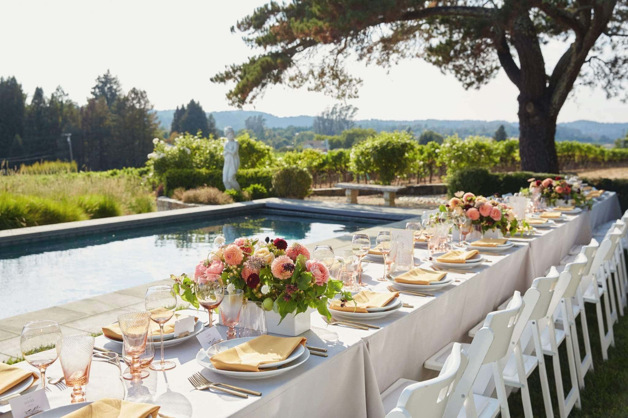 Jacksonville luxury wedding planner arranging floral centerpieces for a reception table
