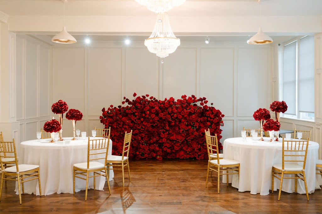 Dramatic red rose wall and chandelier for Miami luxury wedding decor