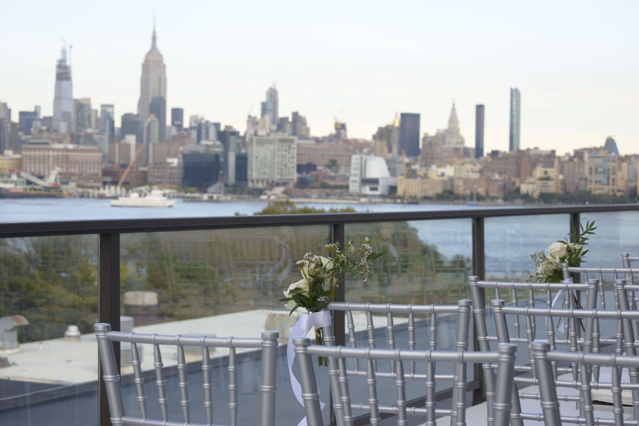 Rooftop ceremony setup with New York skyline and formal seating