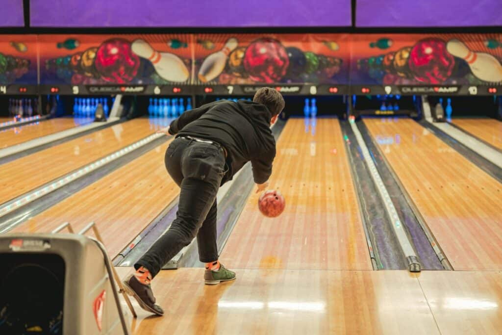 man bowling at bowling alley