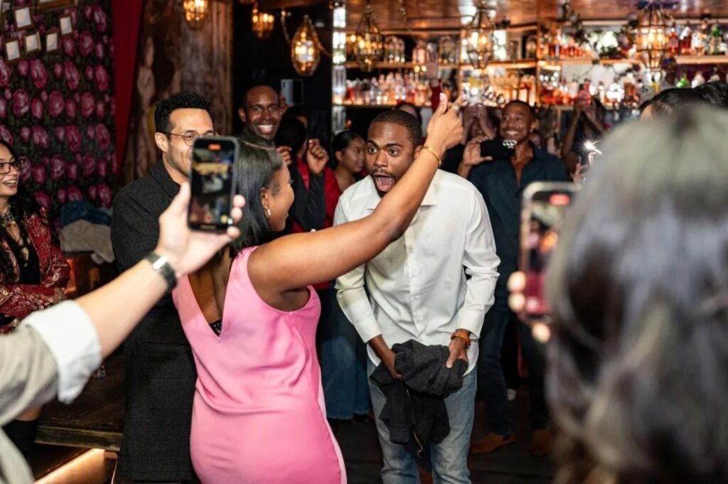 a man and woman dancing excitedly in a crowd