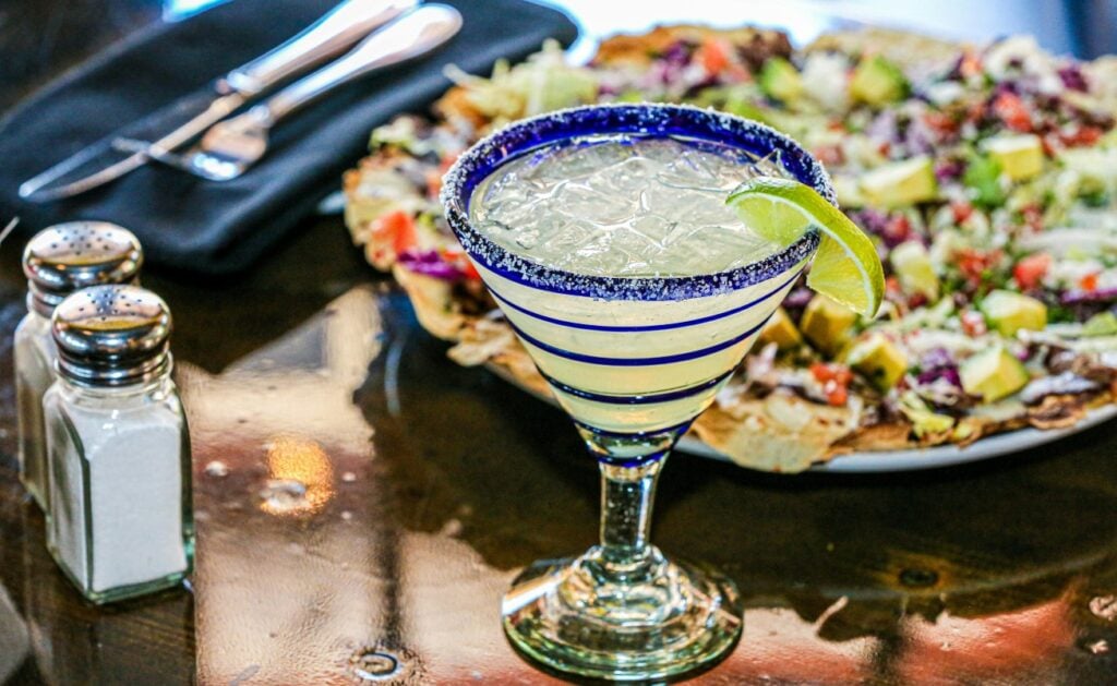 a margarita and nachos set on a table