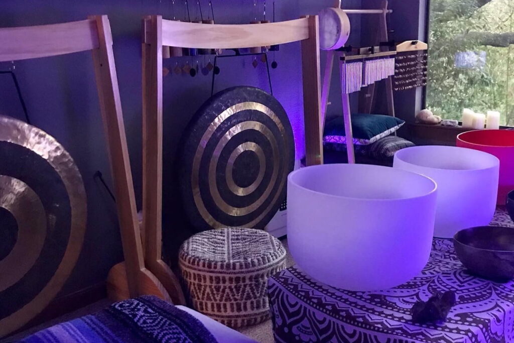 Sound bowls sit on upholstered chairs at a mediation bar