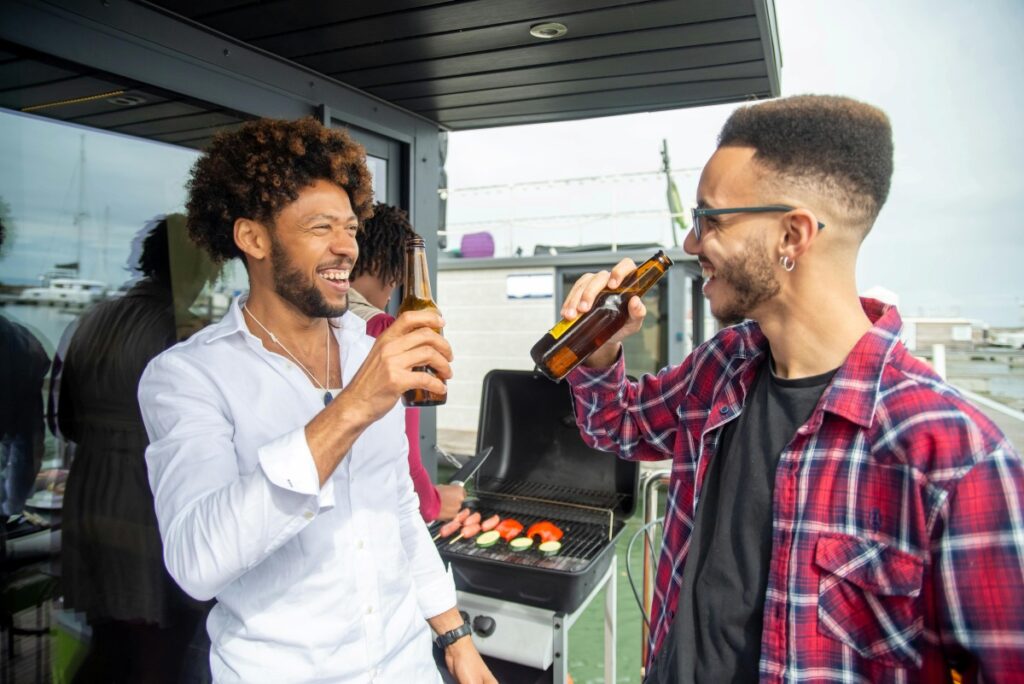 men laughing and drinking beer at a bbq