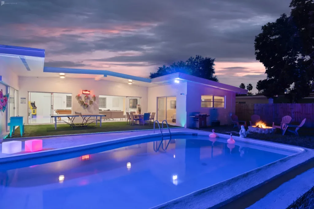 a backyard pool with neon lights