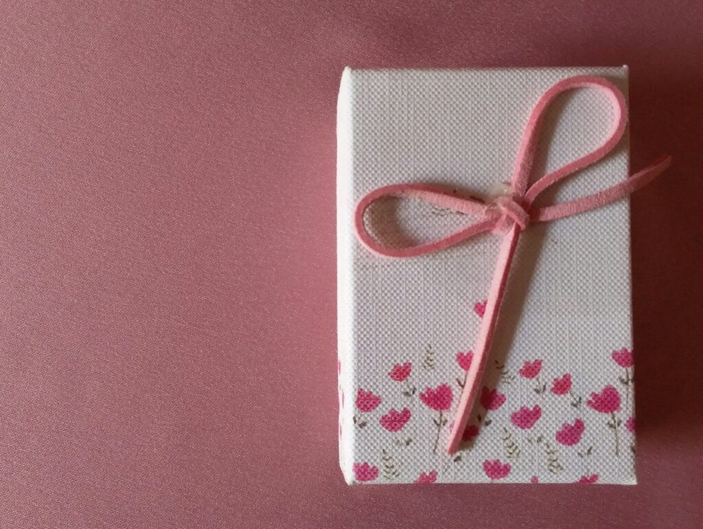 Galentine's gift idea wrapped in a box with pink flowers and bow