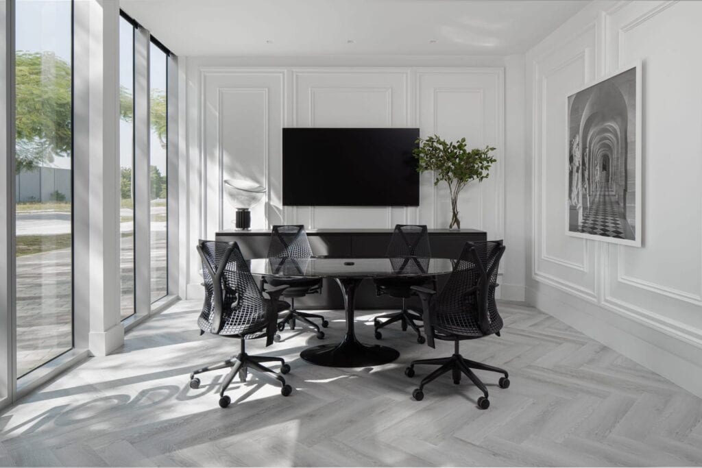 Modern conference room in Miami with white walls, black furniture and floor-to-ceiling windows