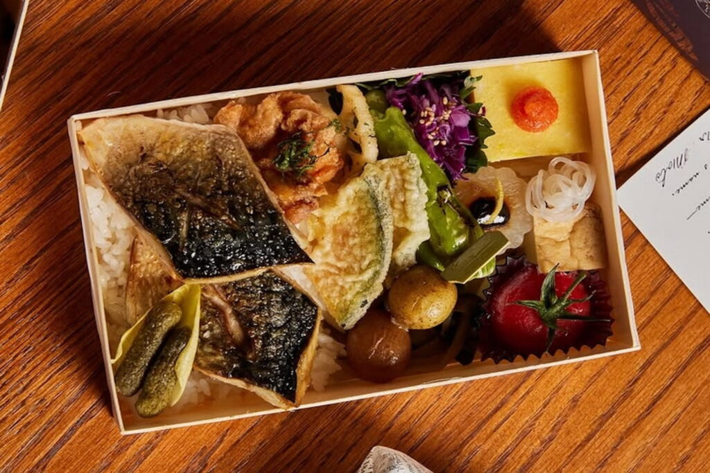 Overhead shot of a square container with a selection of items from Mr. Moto in NYC