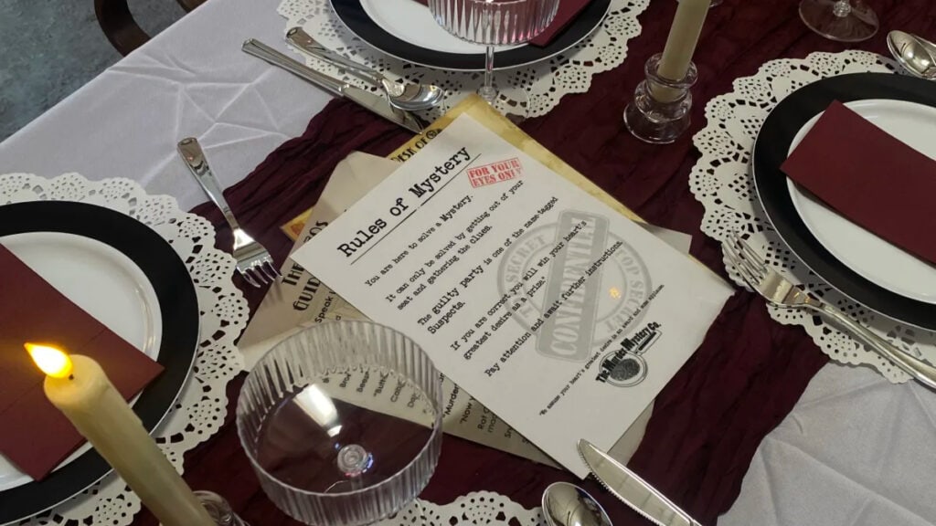 muder mystery instructions sit on a table ready for a birthday party