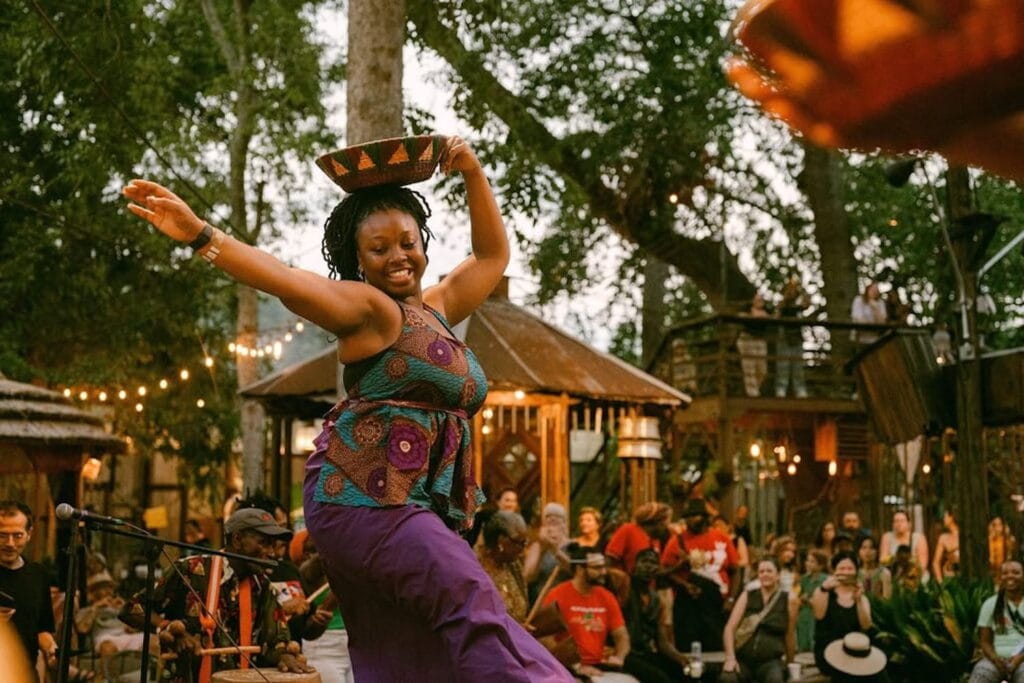 A woman dances as a band plays in front of a crowd in New Orleans