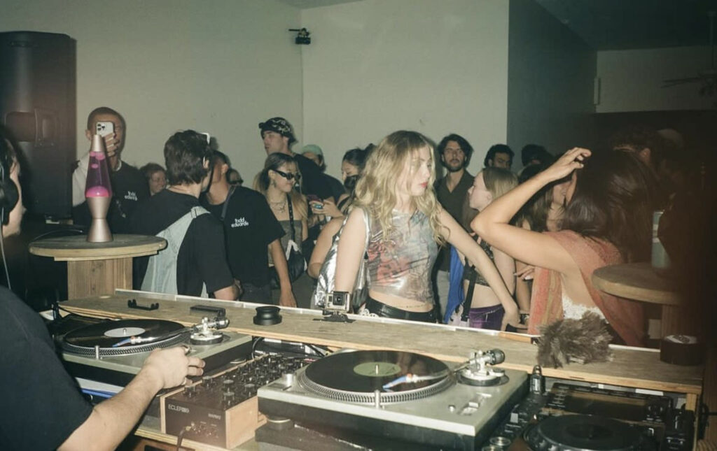 people dancing to dj at house party