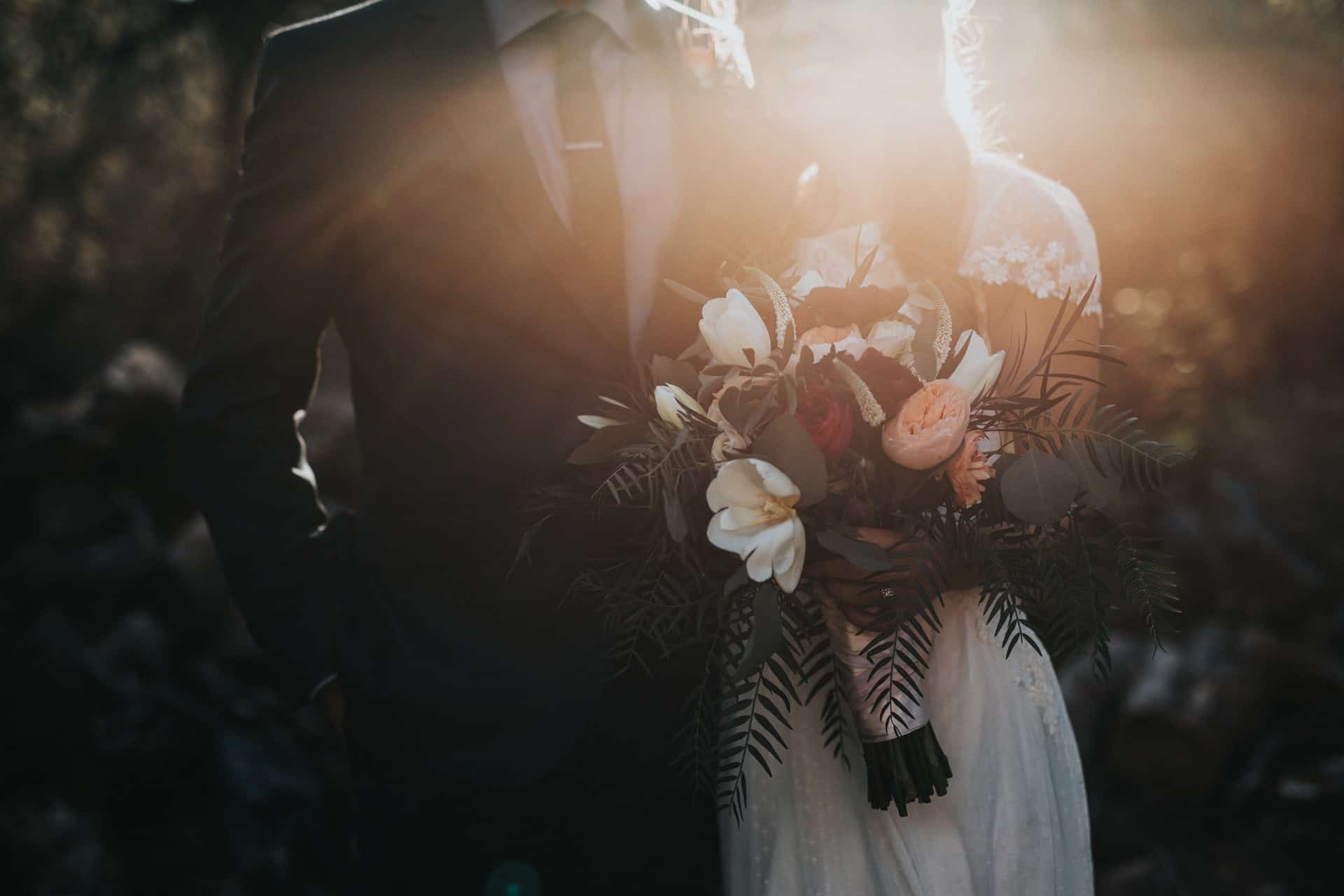 bride and groom with sunflare