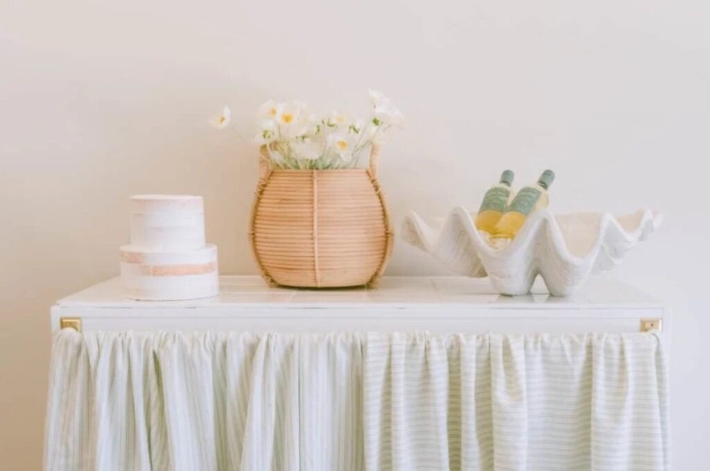 wine, cake and flowers on a white table