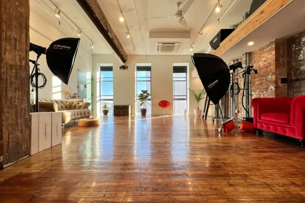 A production space with lighting equipment and a red couch