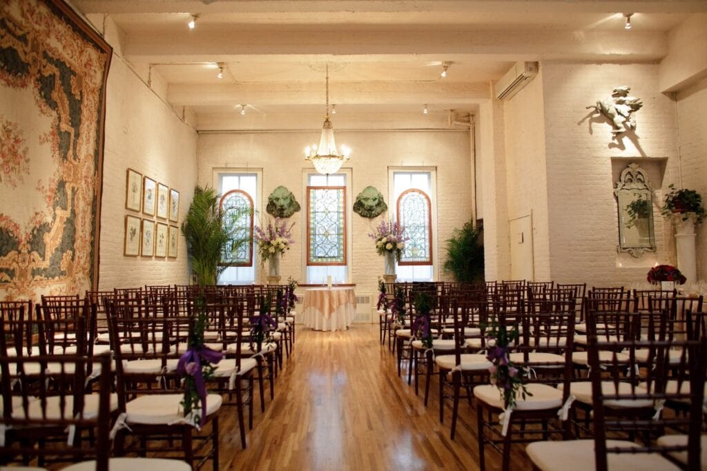 A New York City loft with painted brick walls and stained glass windows is set up for a wedding reception