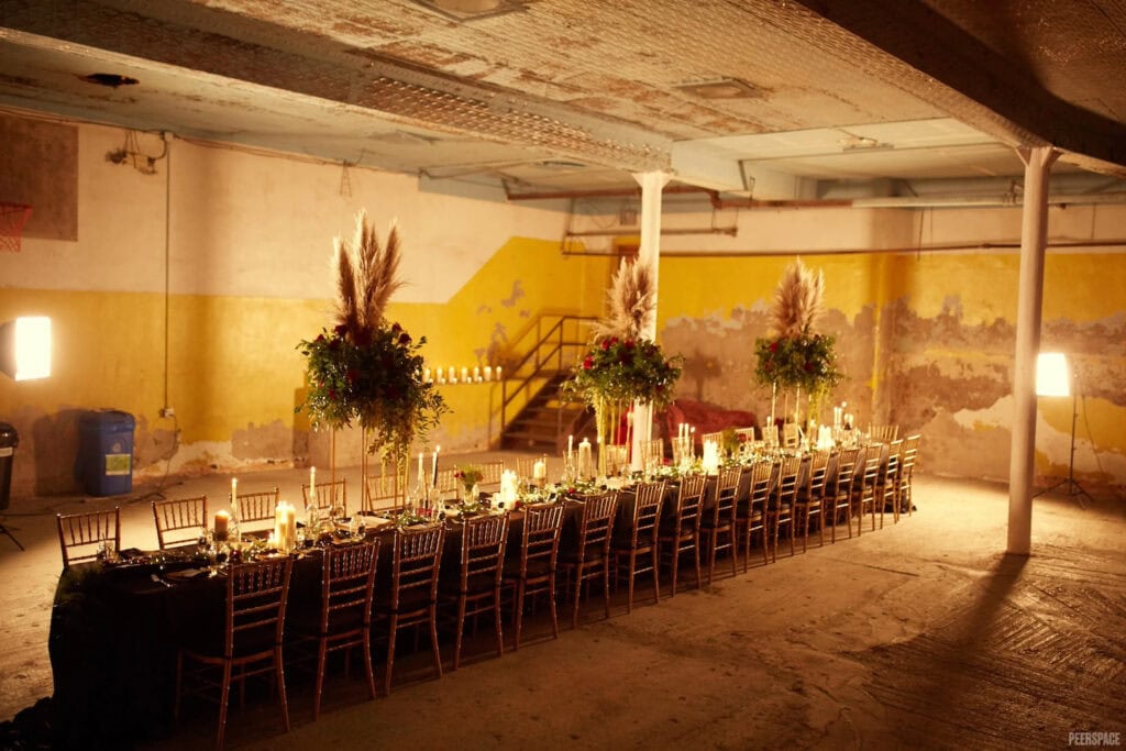 Formal dinner party set up in converted NYC warehouse