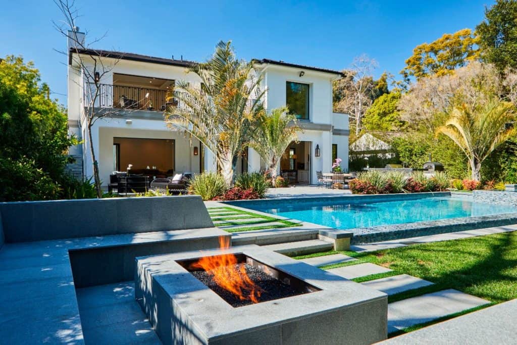 A mansion in Los Angeles with a swimming pool and firepit