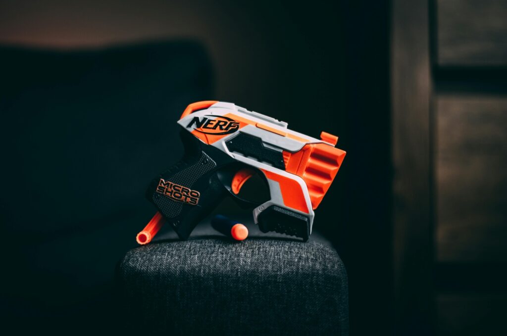 orange nerf gun against black background
