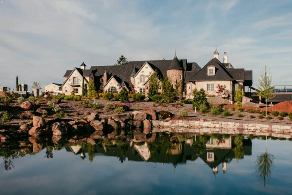 a large castle in oregon overlooking a lake